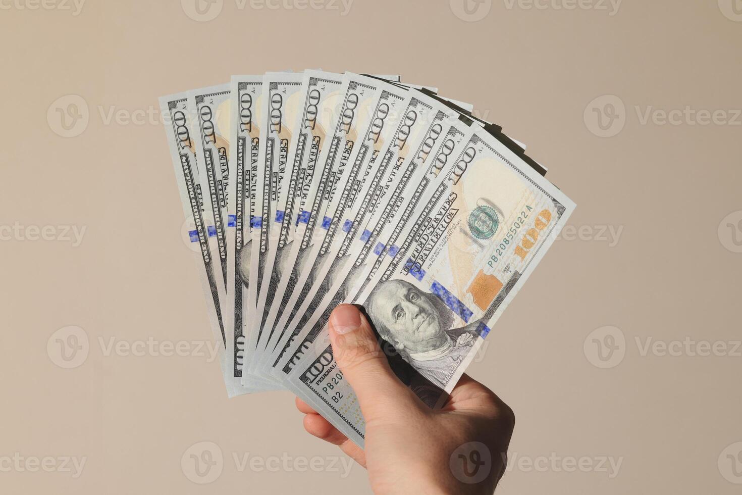 Hand Grasping a Stack of Money A Concept Representing Financial Wealth and Abundance photo