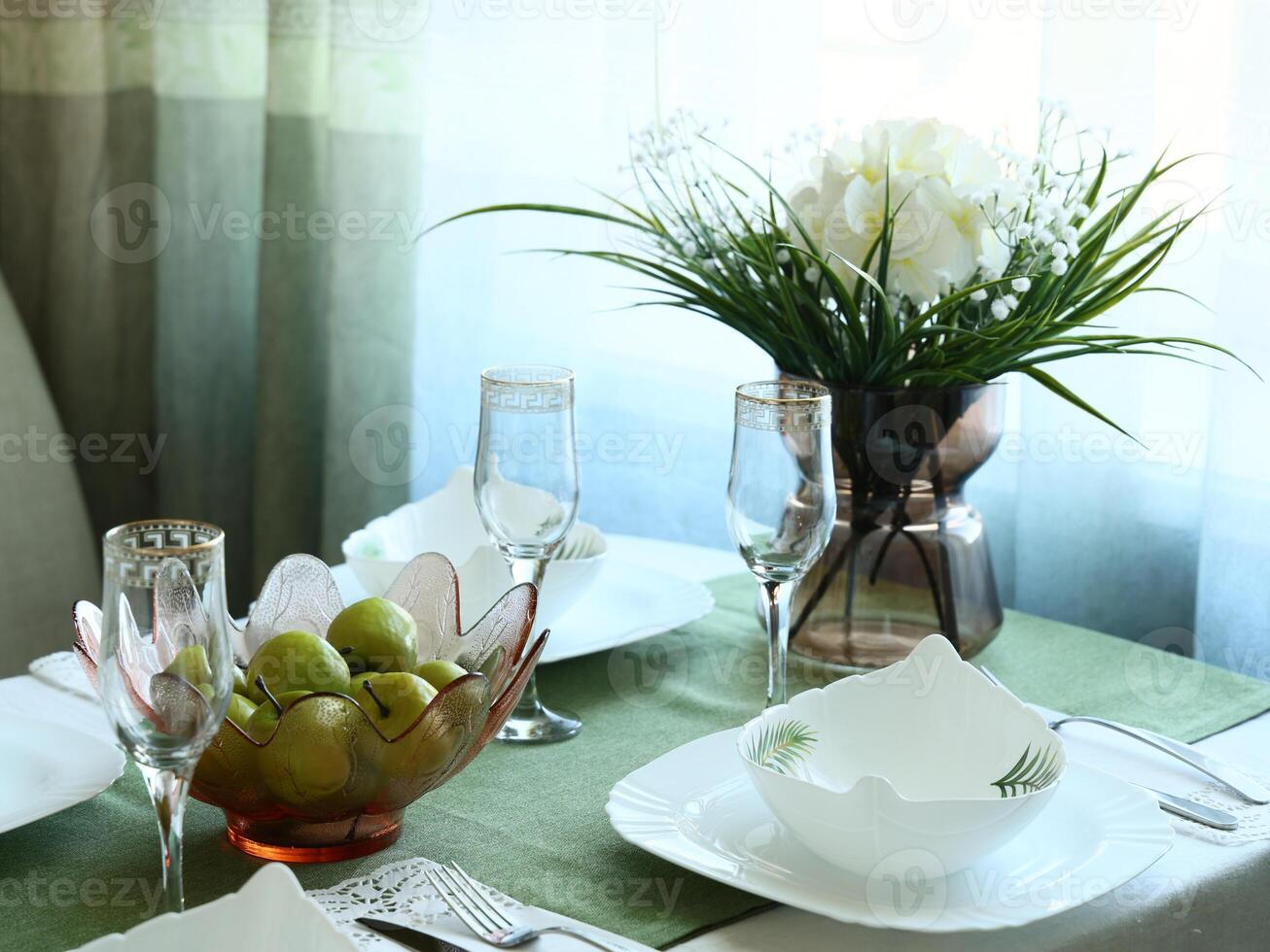 An Elegant Dining Table Setting Featuring Fresh Fruits, Beautiful Flowers, and Chic Cutlery photo