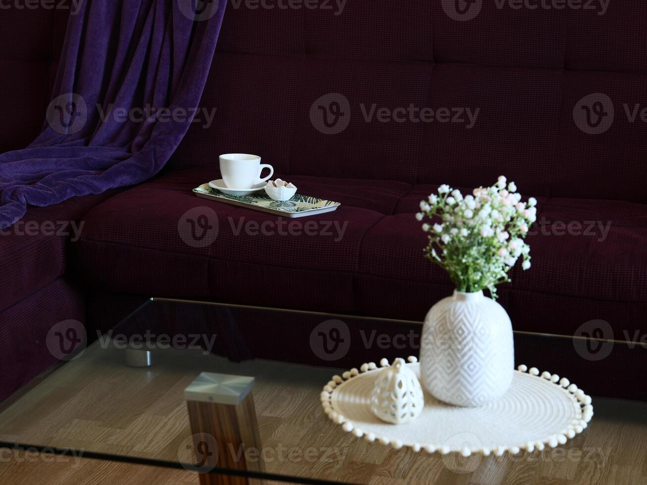 A Cozy Living Room Setup that Features Beautiful Flowers and a Delightful Tea Experience photo