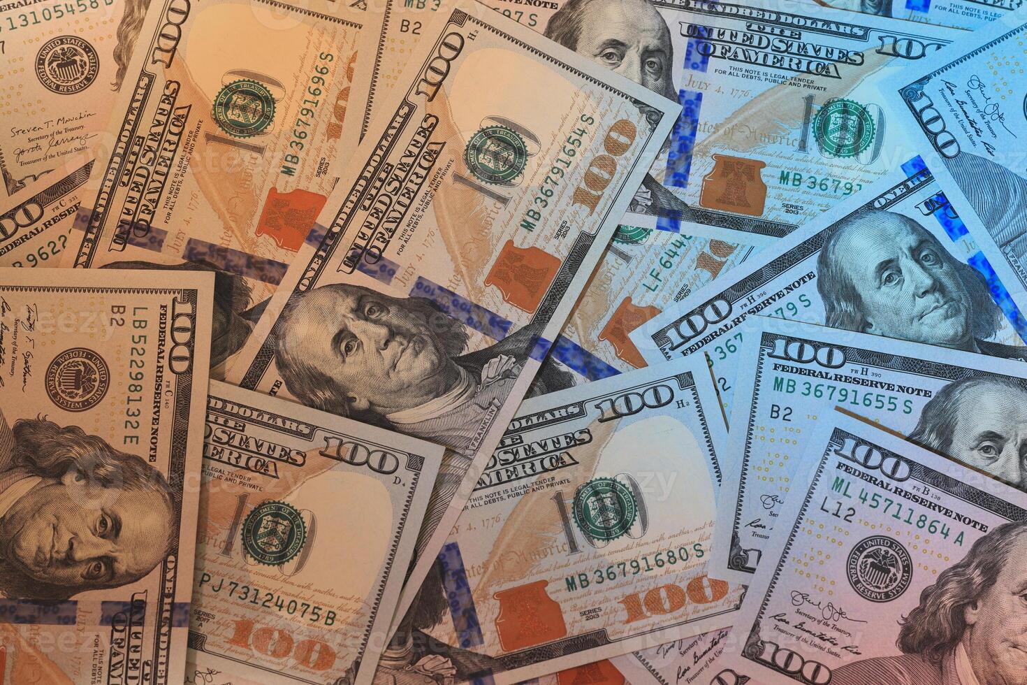 Numerous Stacks of U.S. Dollar Bills Neatly Arranged on a Table Surface for Display photo