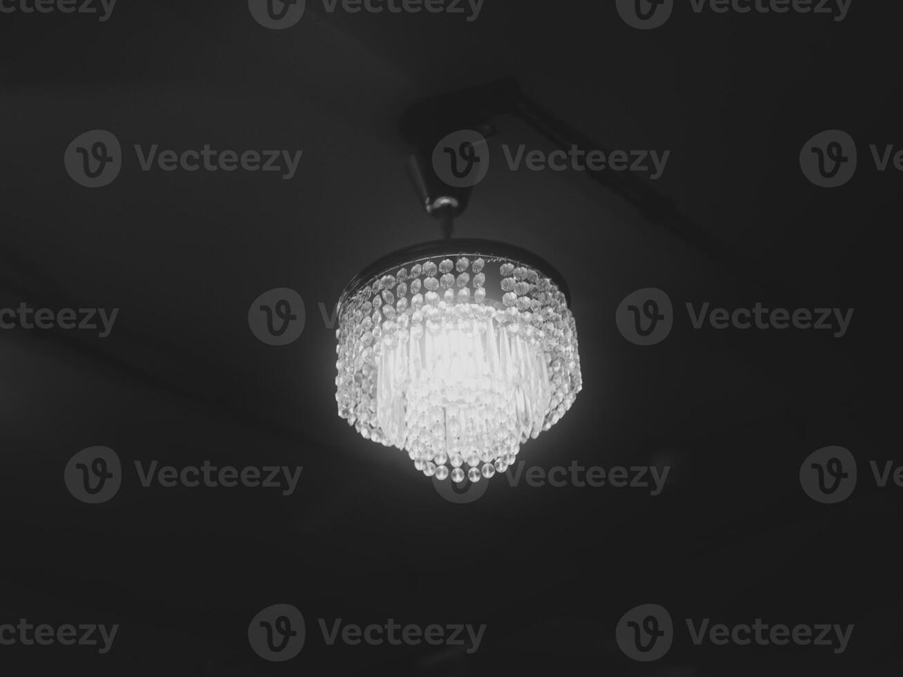 An Elegant Chandelier Gracefully Illuminating a Dark Space with Sophisticated Ambiance photo