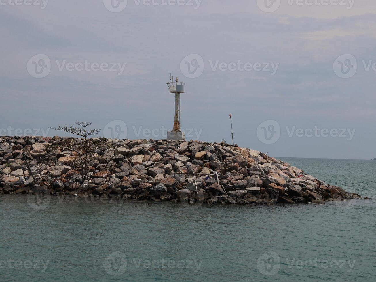 This is a fascinating Coastal Structure crowned by a beautiful Lighthouse situated on a Rocky Jetty photo