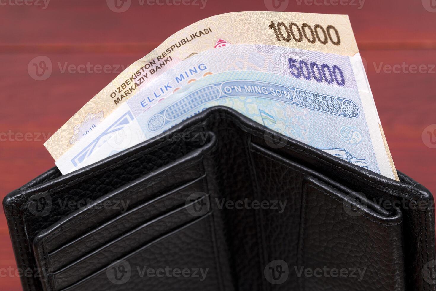 Uzbekistani money - sum in the black wallet photo
