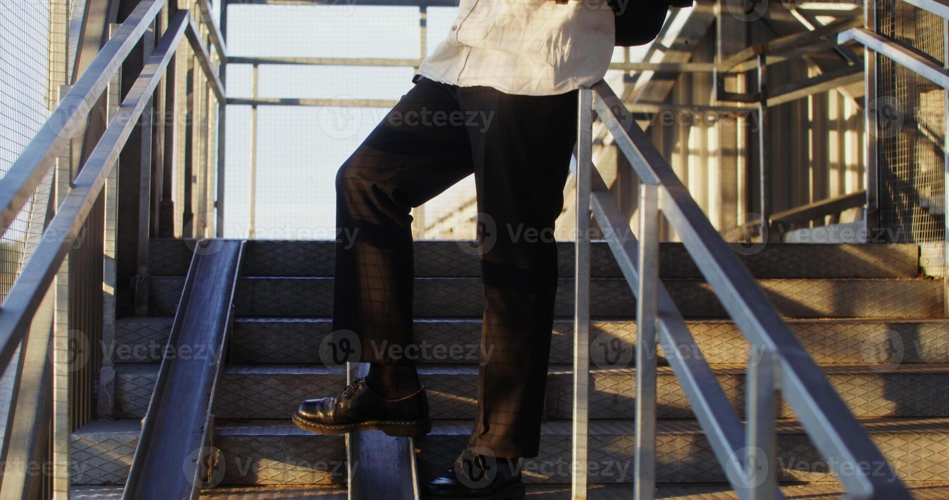 A woman wearing a white shirt and black pants photo