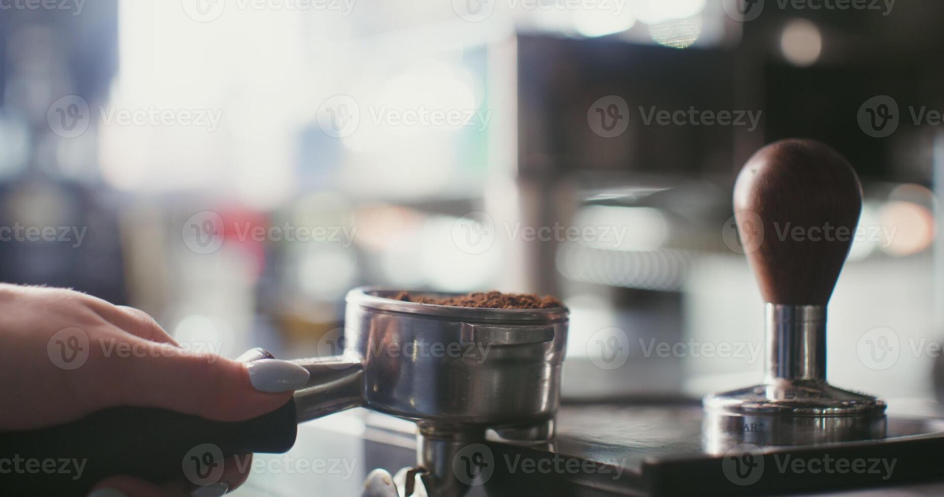 A person is using an espresso machine to make coffee photo