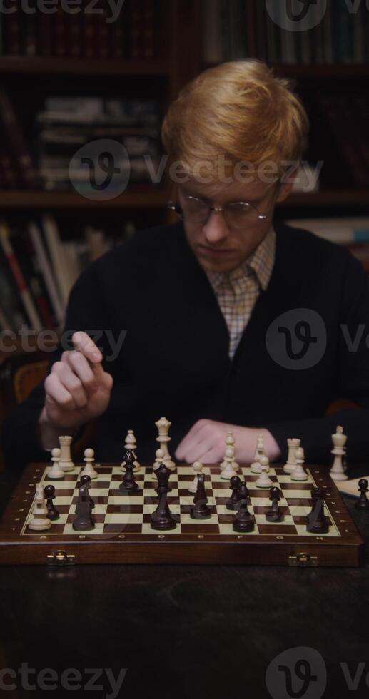A man playing chess on a table photo