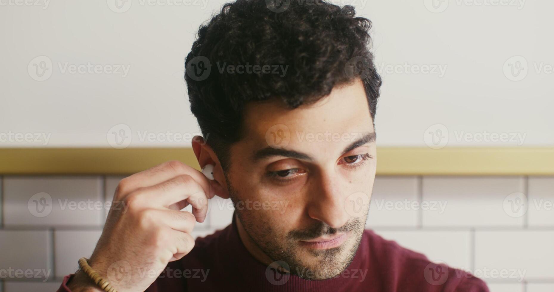 A man is adjusting his ear buds photo