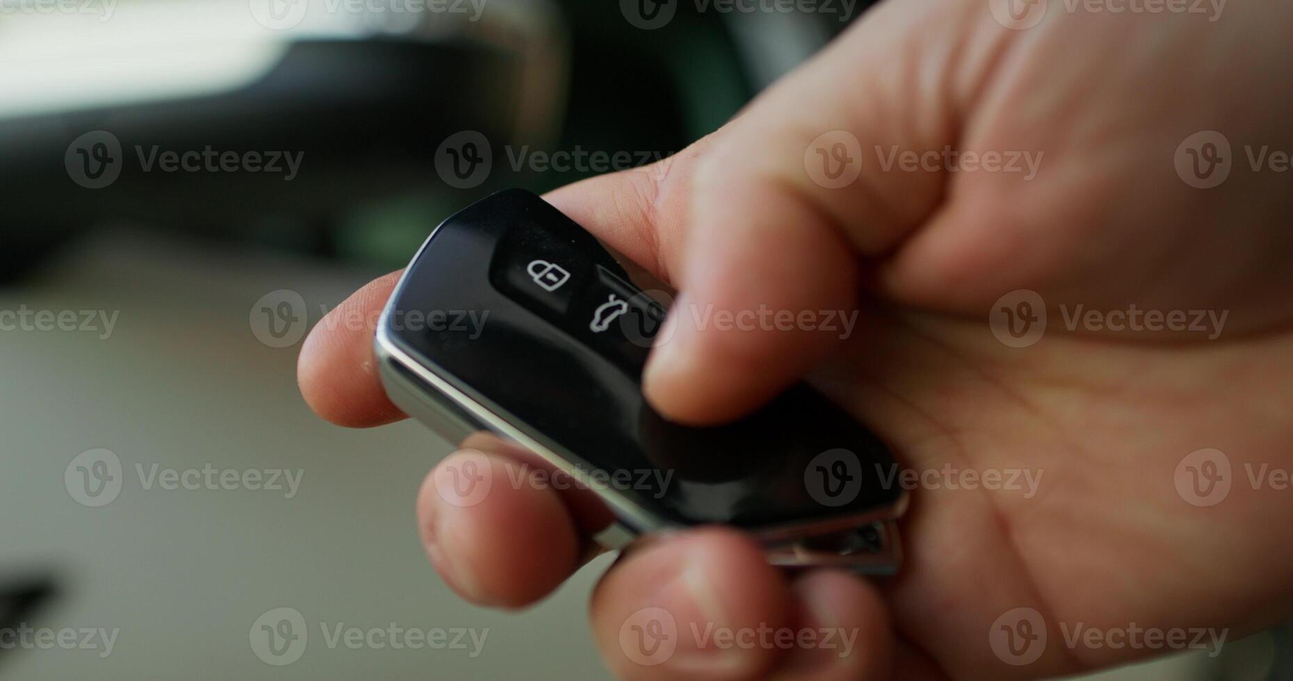 A person holding a remote control in their hand photo