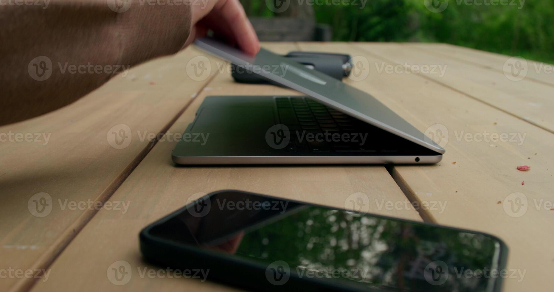 A person is using a laptop on a table photo