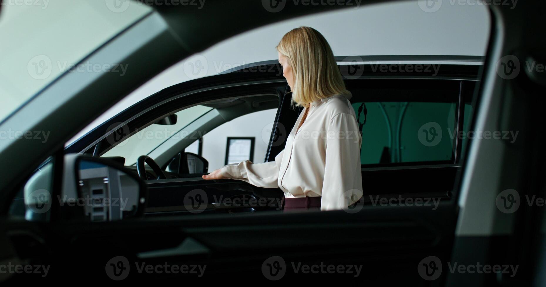 A woman is getting into a car photo