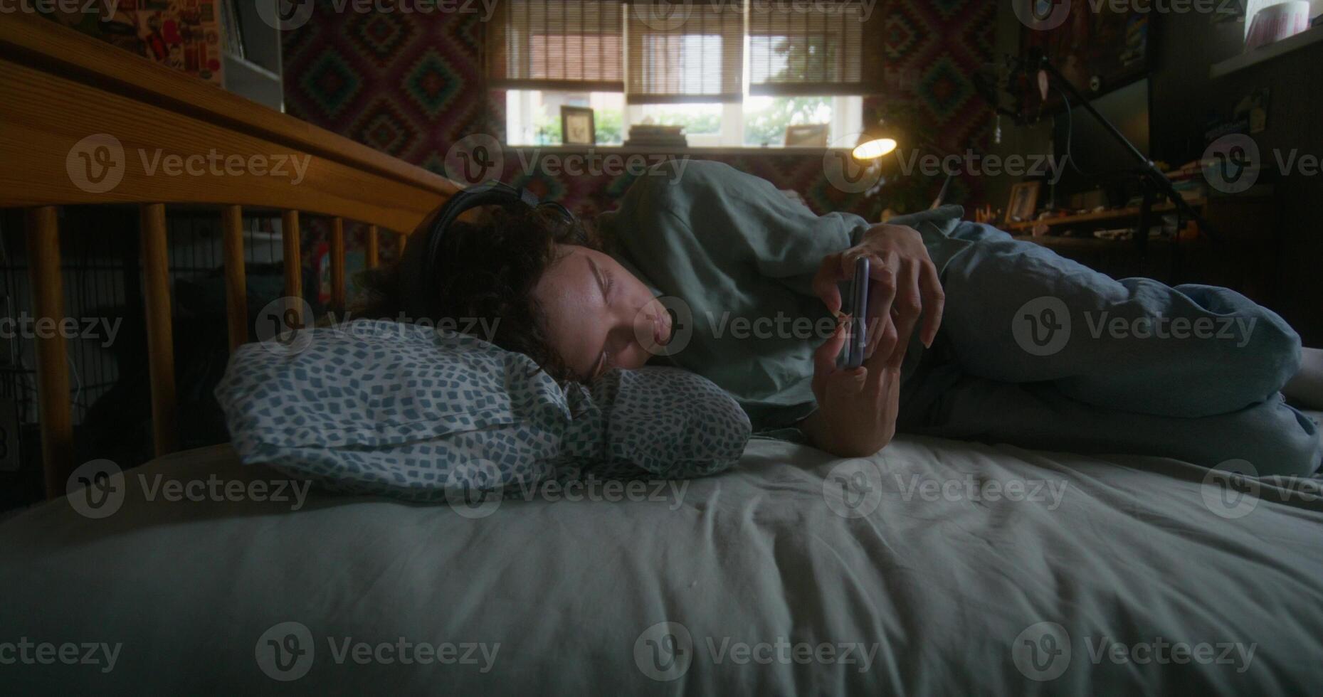 A person laying on a bed with a stuffed animal photo