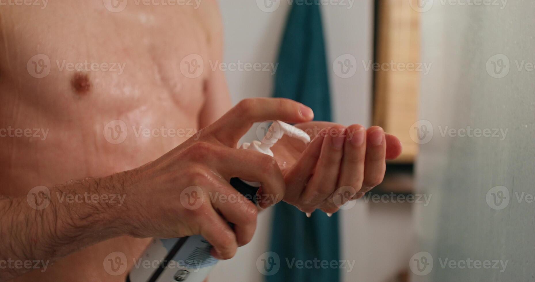 A man is putting on a hand lotion photo