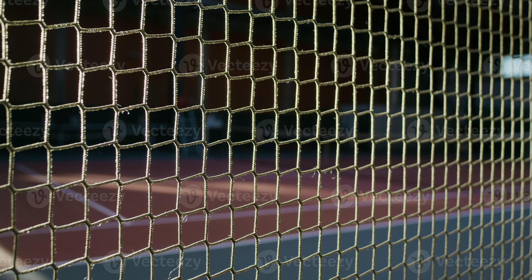 A close-up of a net stretched across an indoor tennis court photo