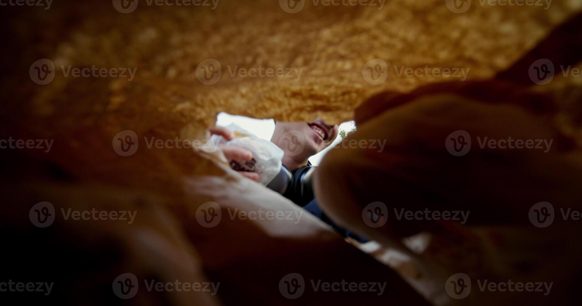A man takes food out of a bag photo