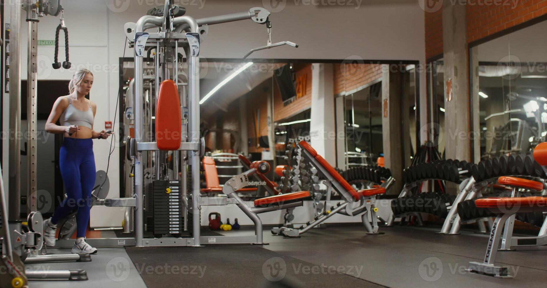 Young woman jumping rope, doing in a modern gym alone photo