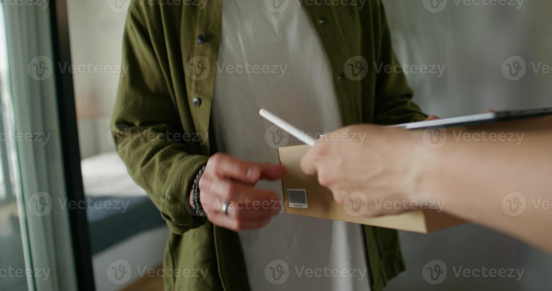 A person holding a box with a pen in their hand photo