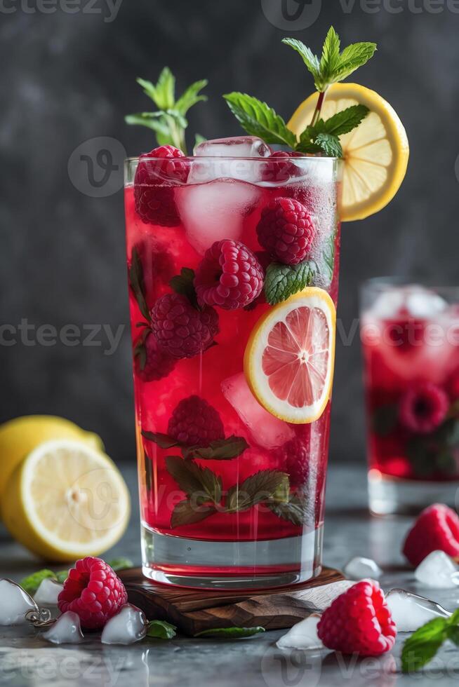 A refreshing raspberry lemonade drink garnished with mint and lemon slices. photo