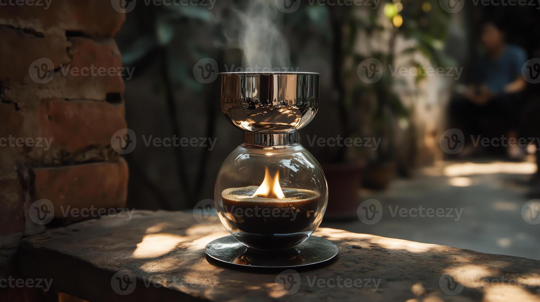 A decorative candle holder emits a gentle flame and smoke in a serene, natural setting. photo