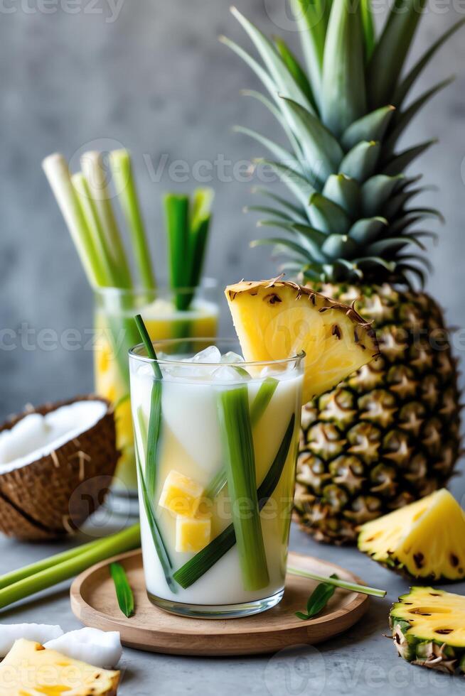 A refreshing tropical drink with pineapple and coconut, garnished with green elements. photo