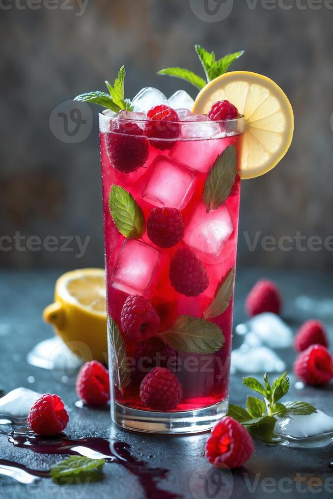A refreshing raspberry drink garnished with lemon and mint, served over ice. photo