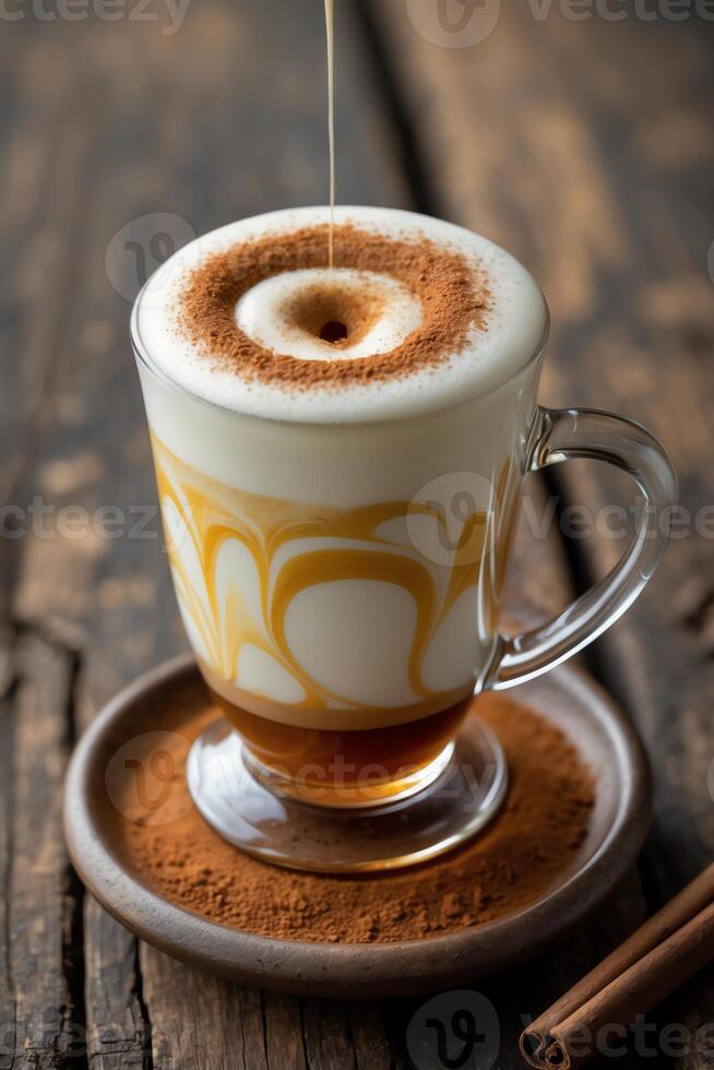 A beautifully layered coffee drink with frothy milk and cocoa topping on a rustic wooden table. photo