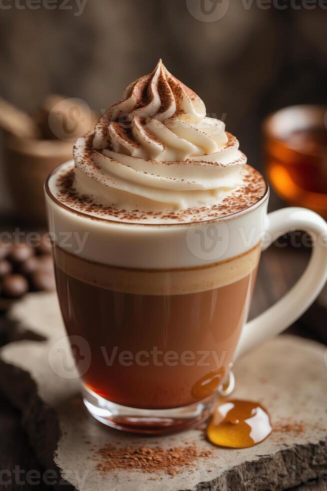 A beautifully layered coffee drink topped with whipped cream and cocoa, served in a clear mug. photo