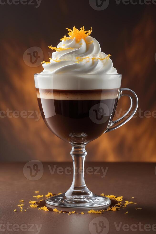 A glass of coffee topped with whipped cream and orange zest against a warm backdrop. photo