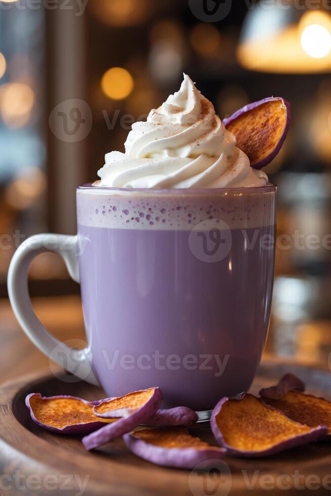 A purple drink topped with whipped cream and a sweet potato slice, served with dried chips. photo