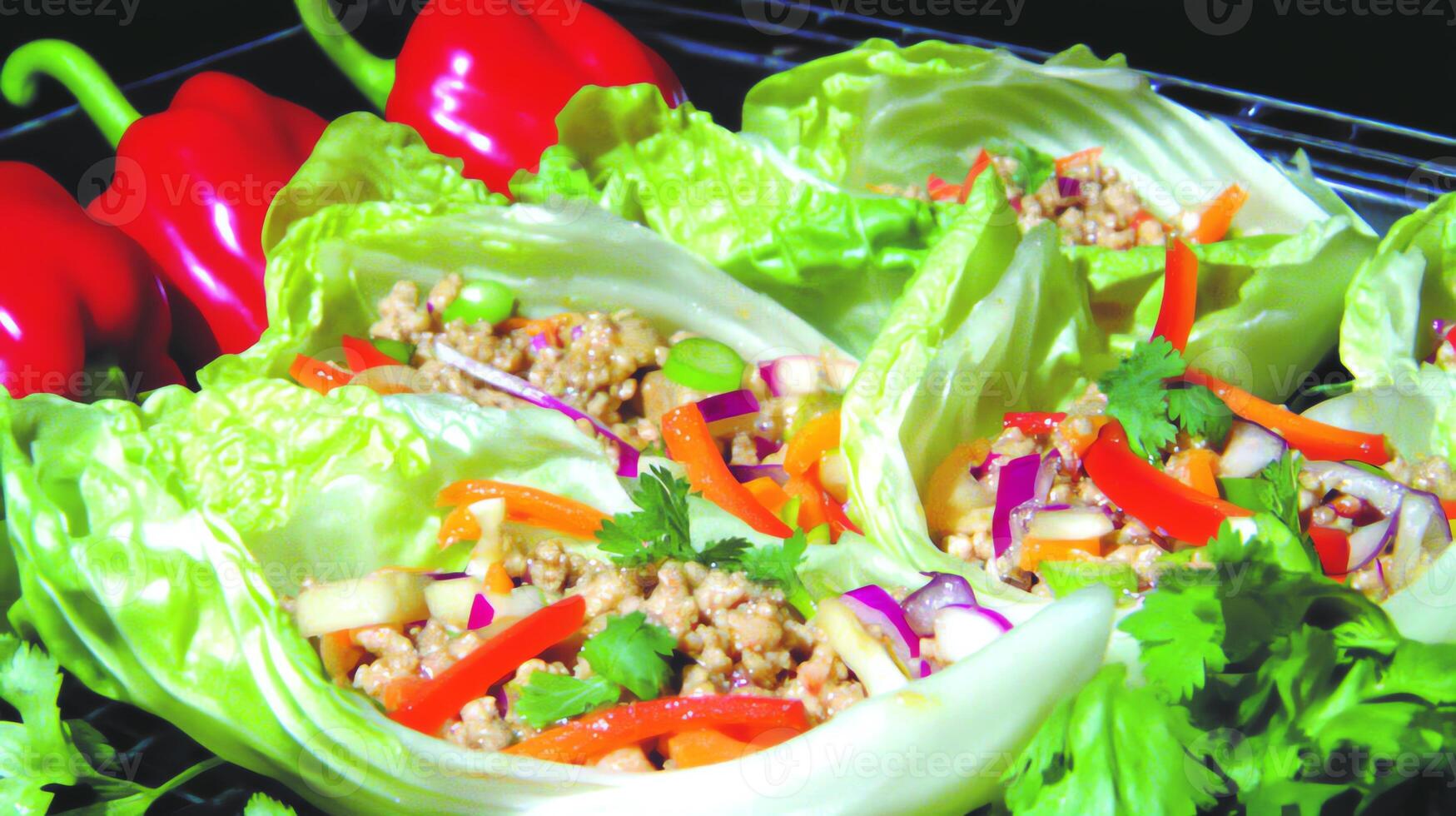 Fresh lettuce wraps filled with colorful vegetables and meat, served as a healthy dish. photo