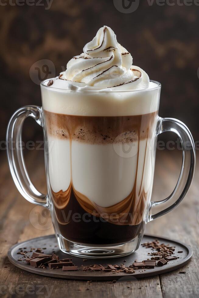 A layered coffee drink topped with whipped cream and chocolate drizzle, served in a glass mug. photo
