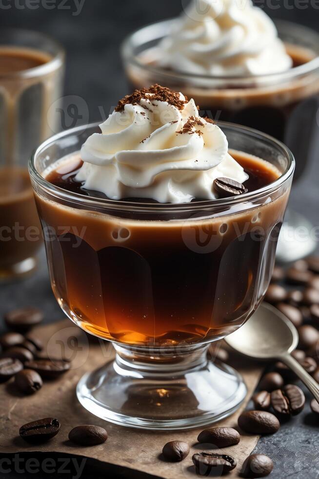 A dessert glass filled with coffee topped with whipped cream and chocolate shavings. photo