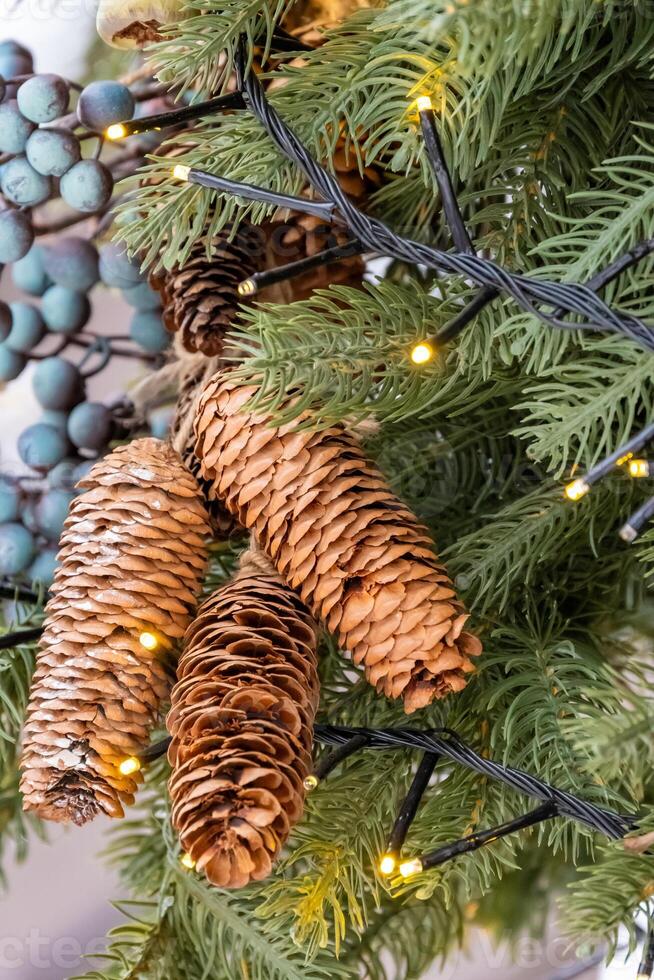 A close up of a christmas tree with pine cones and berries photo