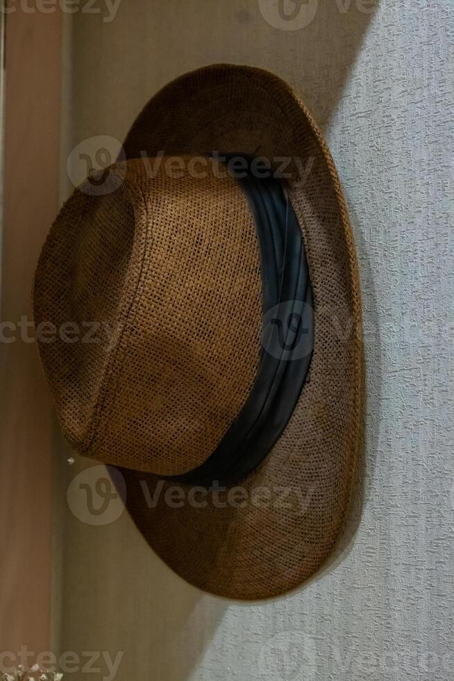 A brown hat on a shelf in a room photo