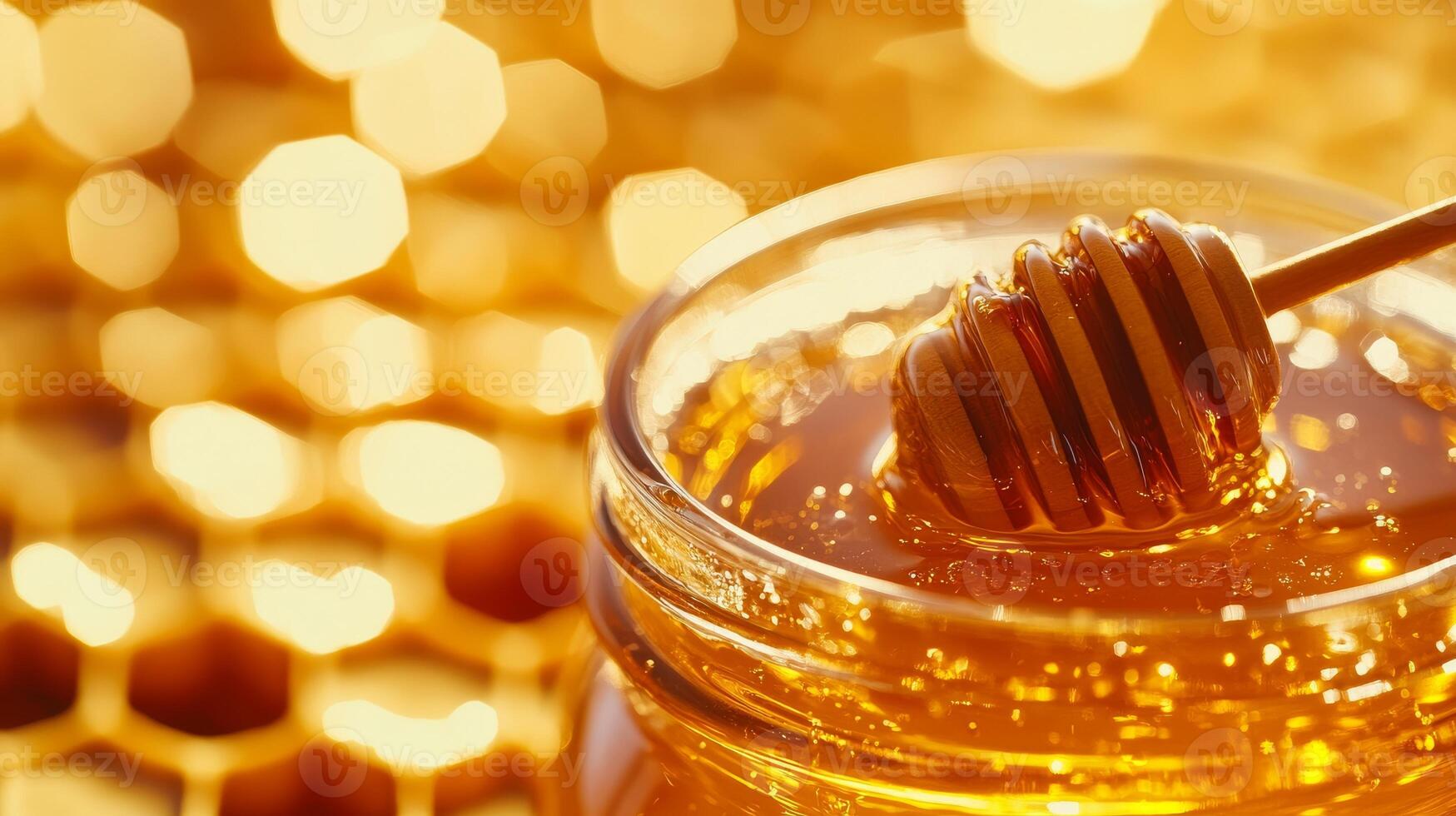 Golden honey dripping from wooden dipper into glass jar with honeycomb background photo