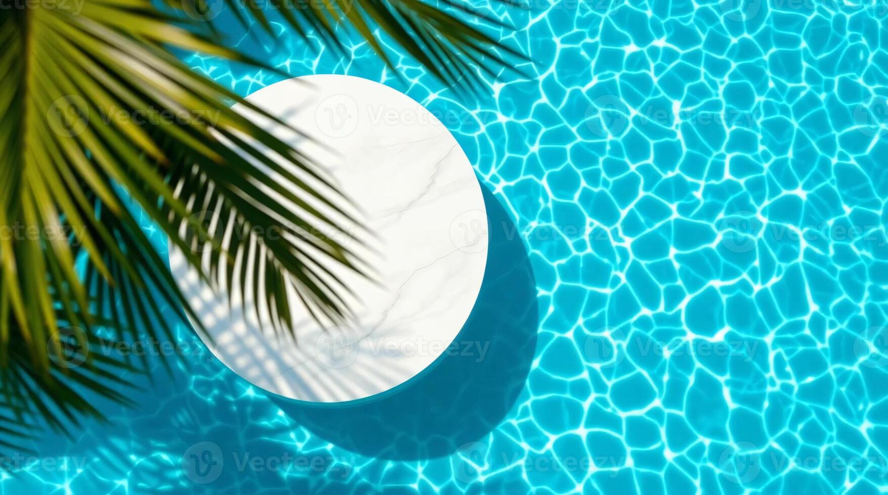 A white round table in a pool with palm trees photo