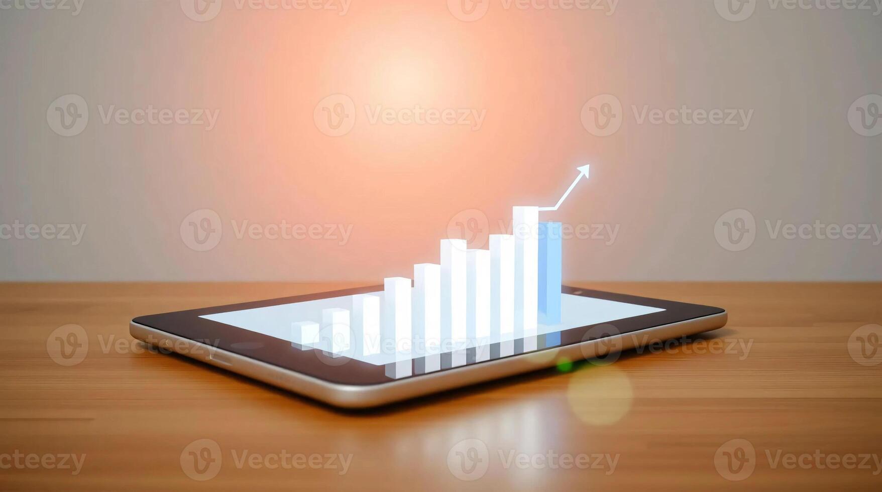 Tablet pc with graph on screen and light on table photo