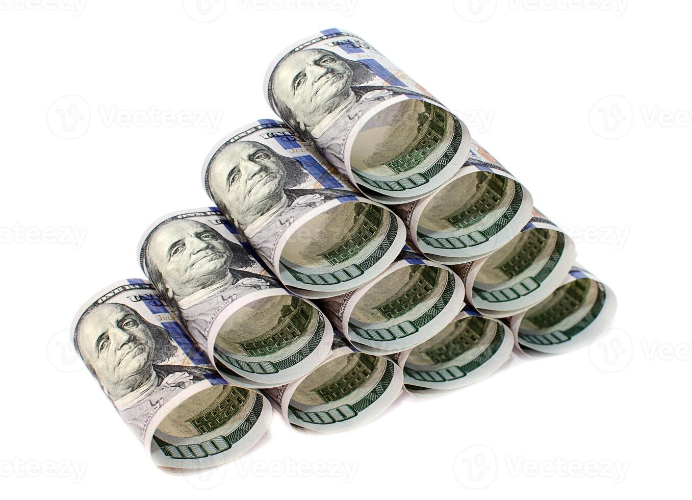 One hundred dollar bills rolled and stacked in a pyramid isolated on a white background photo