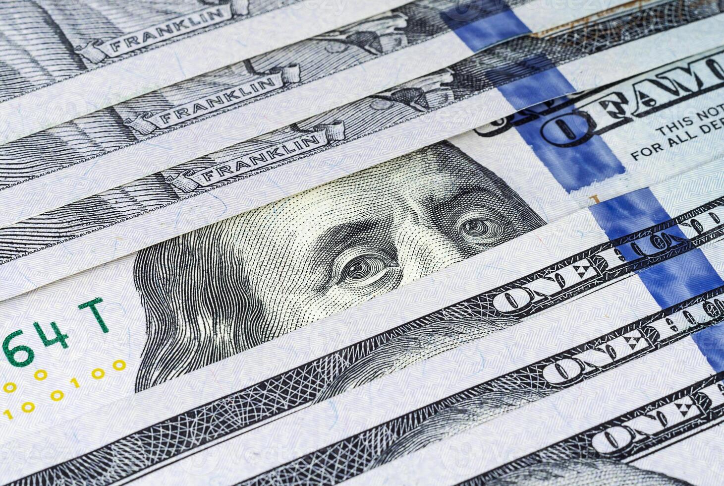 Row of US hundred dollar banknotes closeup photo
