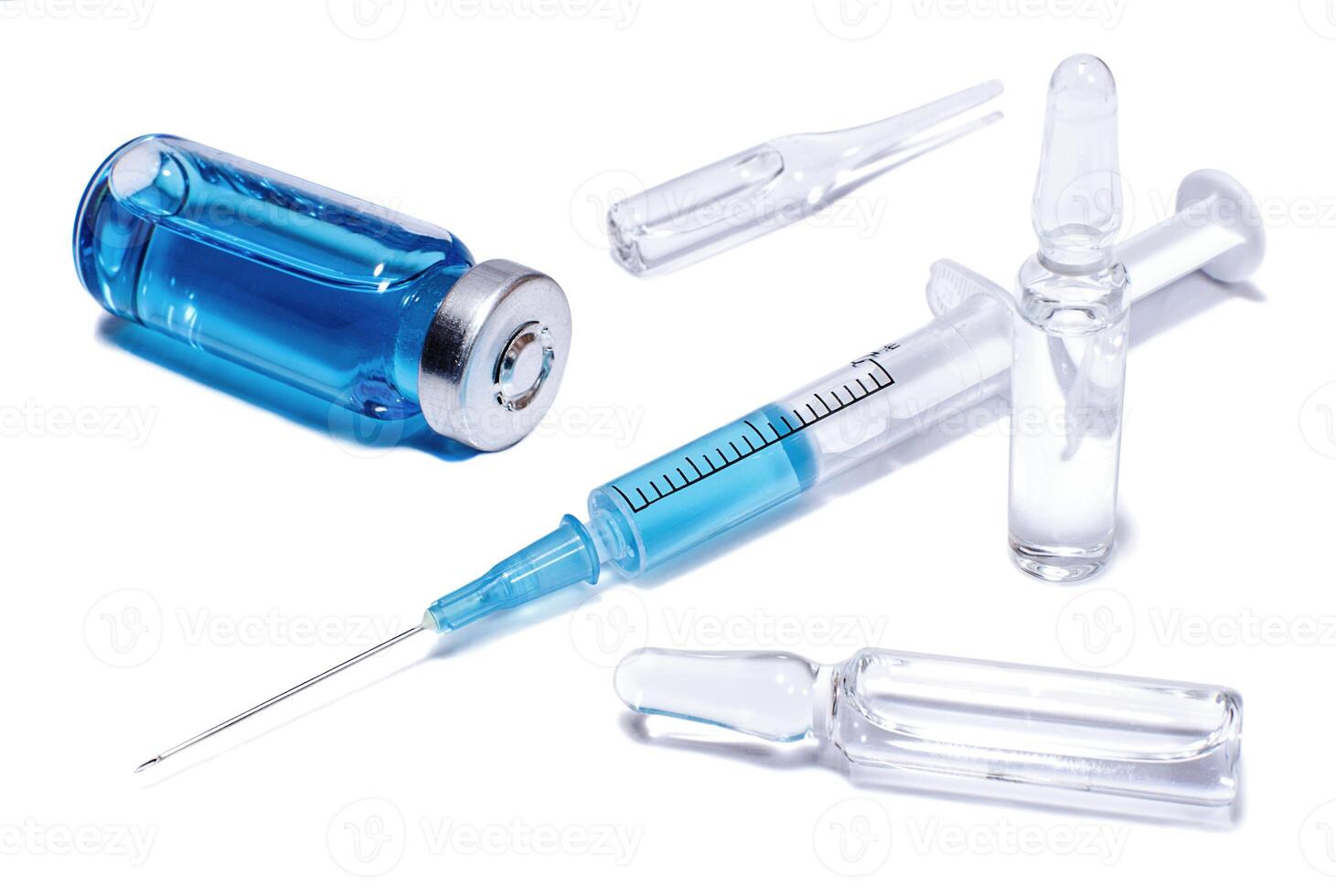 Ampules, phial and syringe with blue vaccine photo
