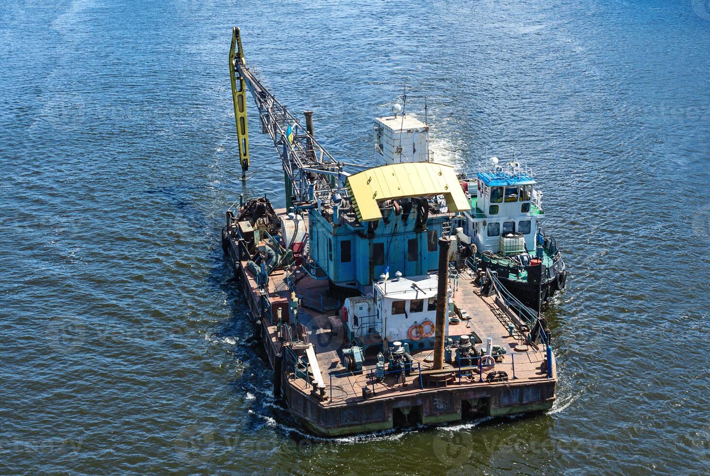 Floating crane and river tug photo
