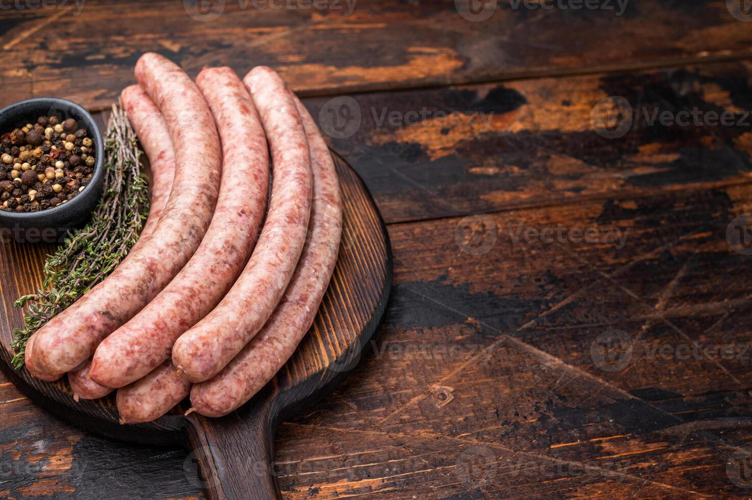 Uncooked sausage on a wooden board, a must have ingredient for delicious homemade recipes and comfort food. wooden background. top view photo