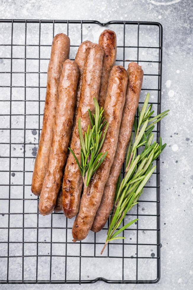 Flavorful grilled sausage links on a rack, inviting you to enjoy a hearty meal with family and friends. grey background. top view photo