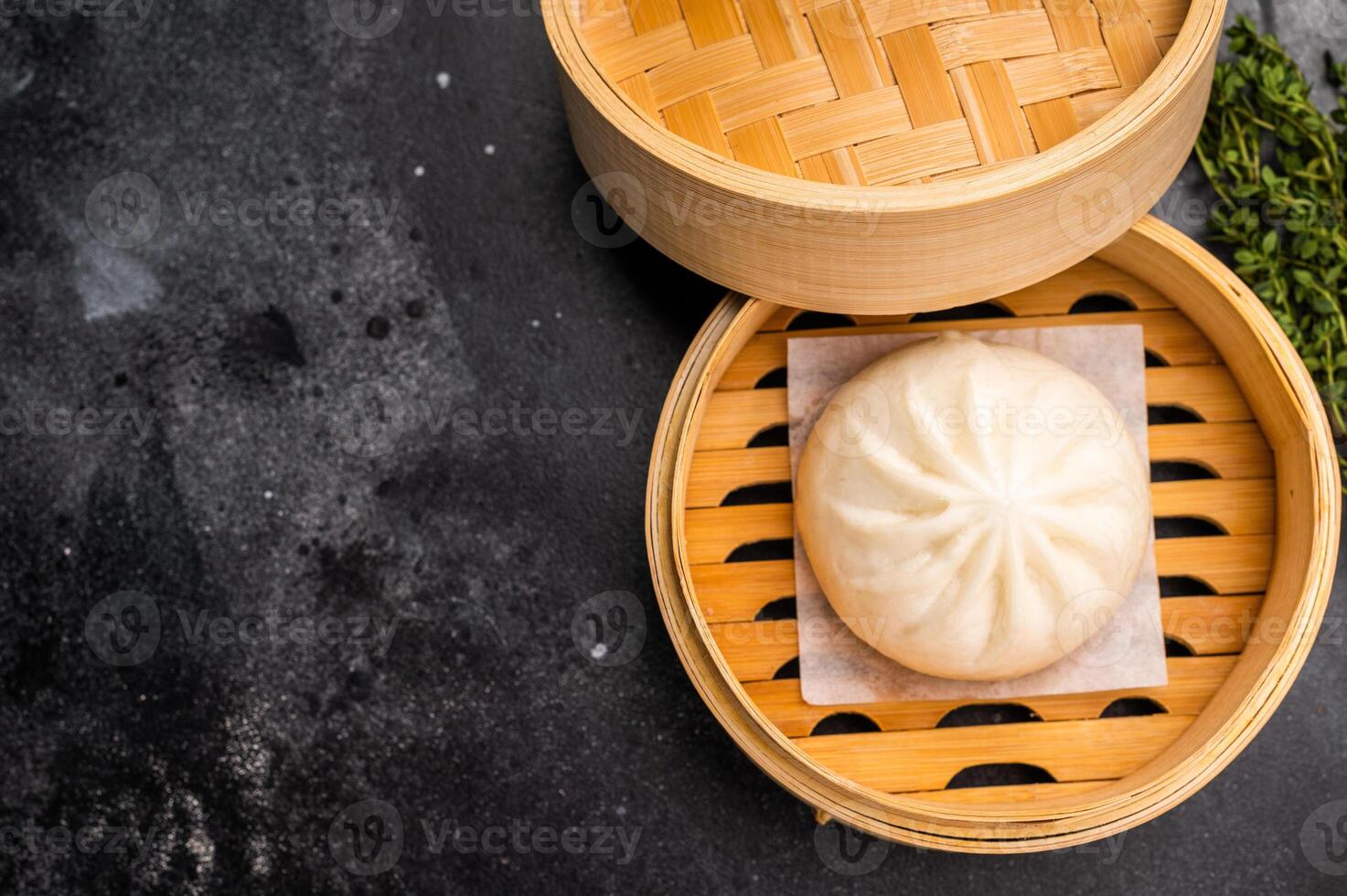Momo with meat in bamboo steamer. black background. top view photo