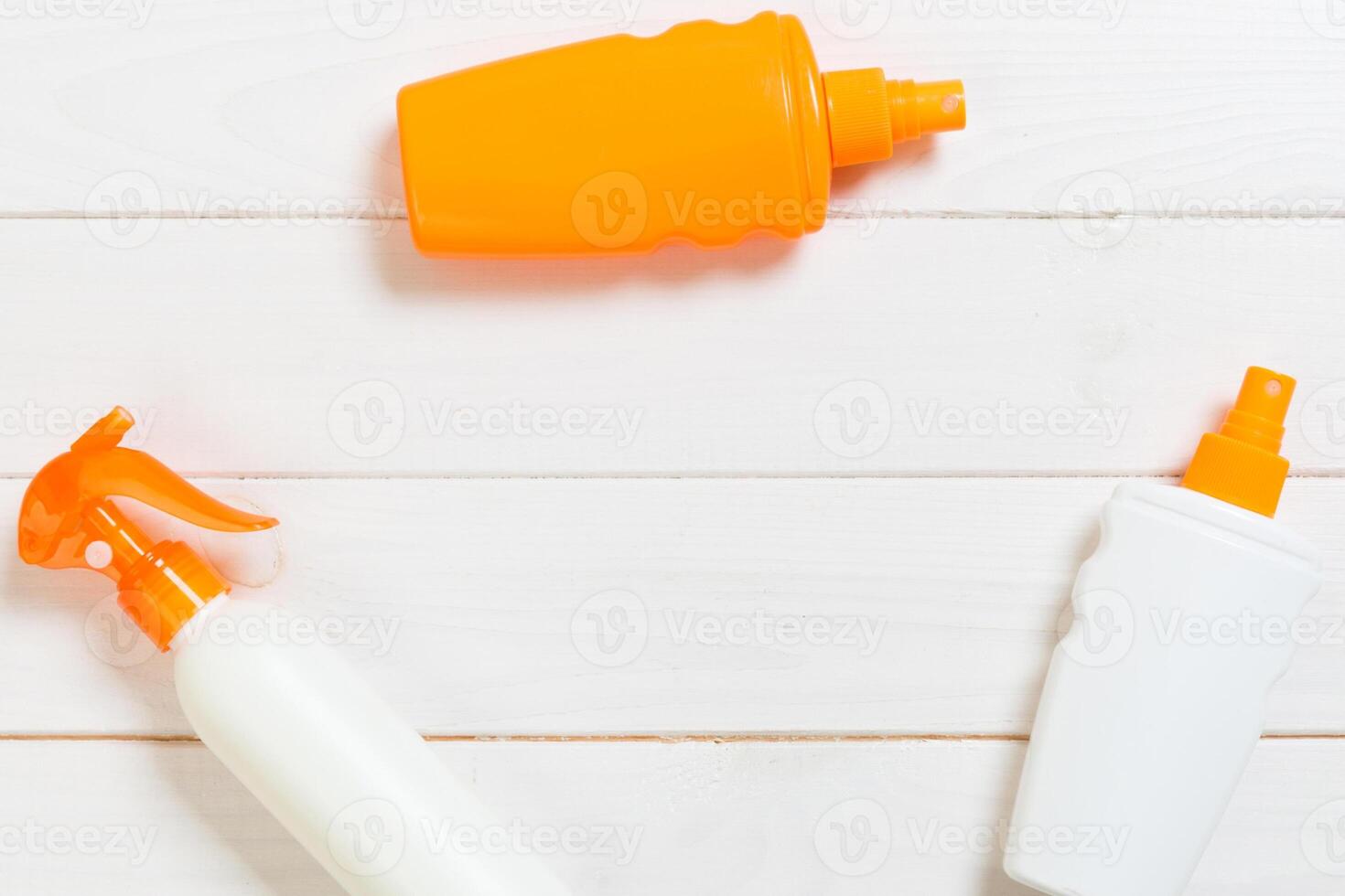 Sunscreen bottles seashells on white wooden table. Travel healthcare accessories top view photo