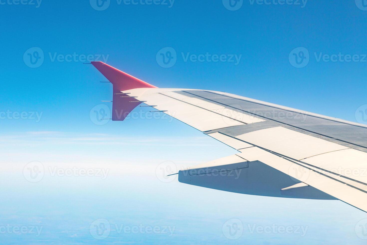 Aircraft wing on the clouds, flies the city background photo
