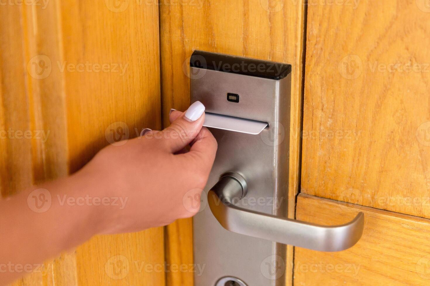 Woman hand with keycard in electronic lock. female hand hold key card and open electronic lock door photo