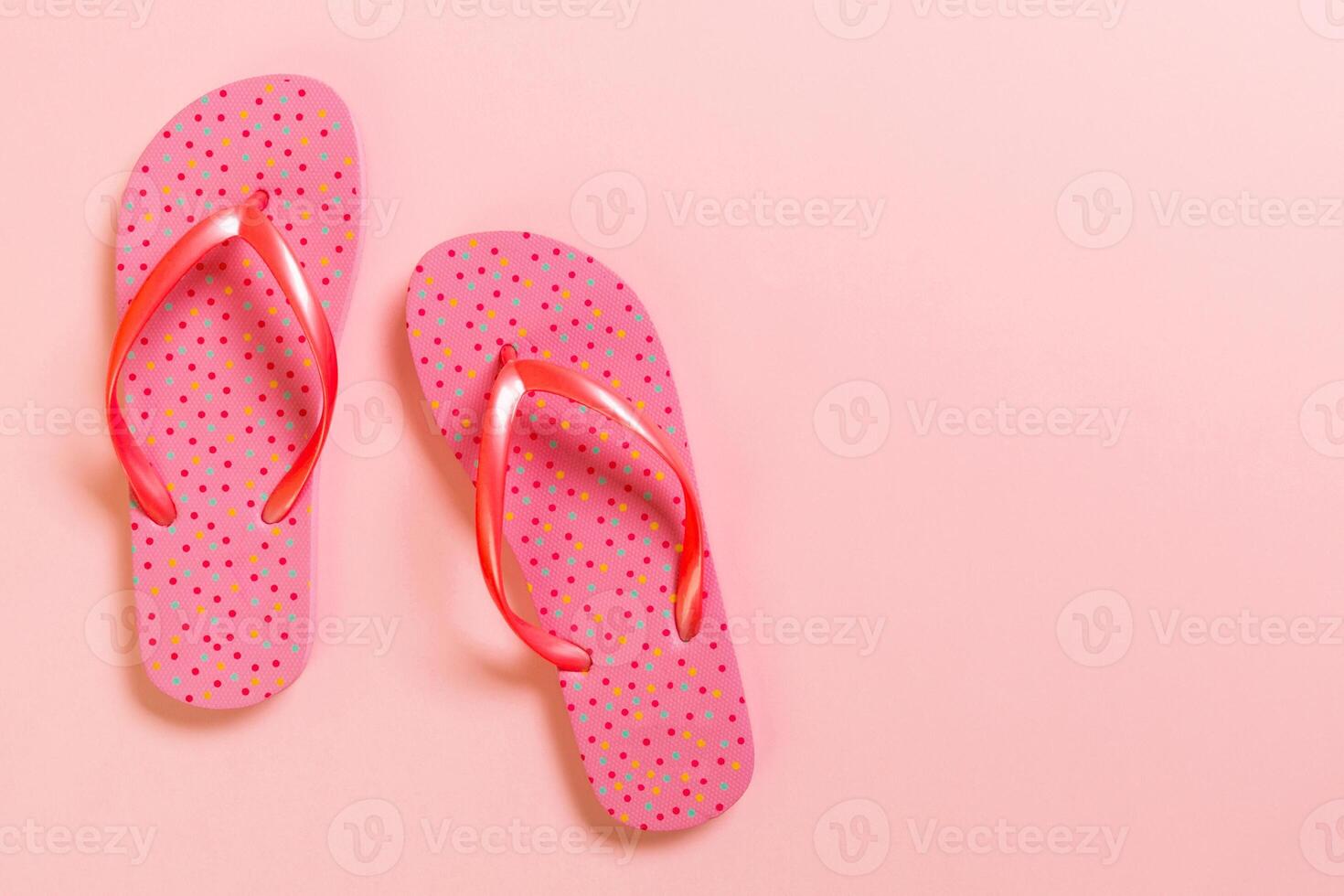 Coral flip flops pink Background. Top view with copy space photo