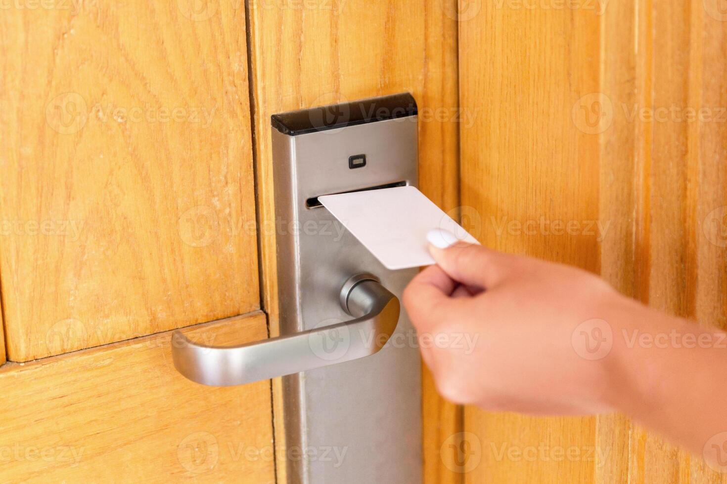 Woman hand keycard in the electronic lock. female hand hold key card and open electronic lock door photo