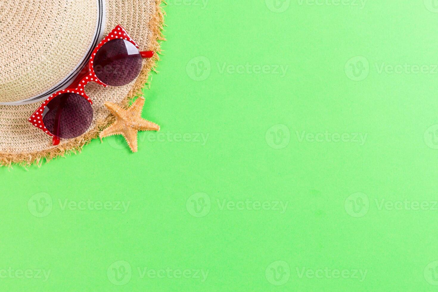 summer holiday beach background accessories on green table, top view with copy space. vacation concept photo