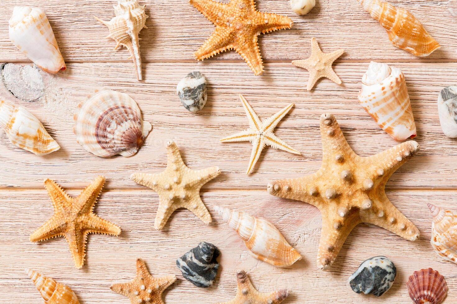 Starfish and seashells background on a wooden table top view, flat lay photo